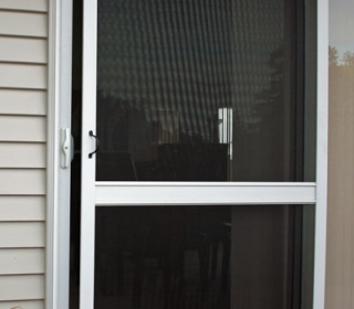 Sliding insect screen door with pet resistant mesh and vision rail